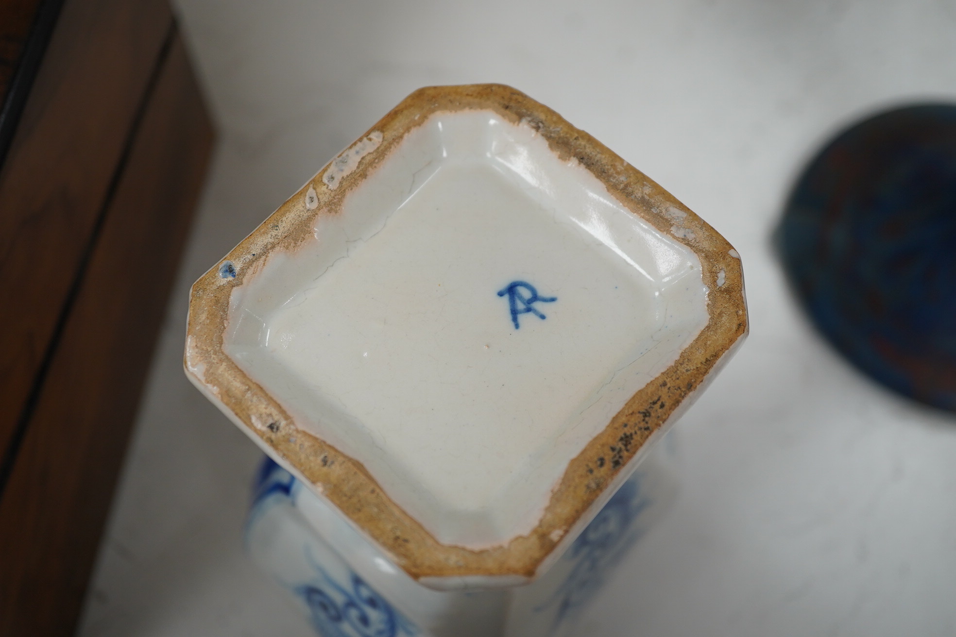 A 19th century Delft blue and white vase and a Watcombe Torquay pottery chamberstick, 19.5cm. Condition - both fair